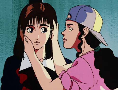 A Girl In A Pink Shirt Is Touching The Face Of Another Girl GIF