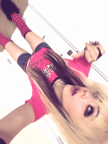 A Girl In A Pink Shirt With The Number 10 On It Is Laying On The Floor GIF