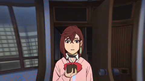 A Girl In A Pink Sweater Is Holding A Wallet In Her Hand GIF