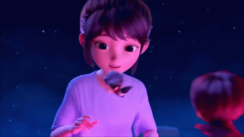 A Girl In A Purple Shirt Is Holding A Stuffed Animal In Her Hand GIF