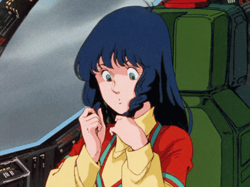 A Girl In A Red And Yellow Shirt Is Sitting In A Green Seat GIF
