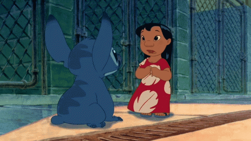 a girl in a red dress is standing next to a blue cartoon character
