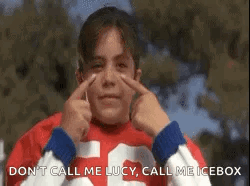 A Girl In A Red Shirt Is Making A Funny Face With Her Hands . GIF