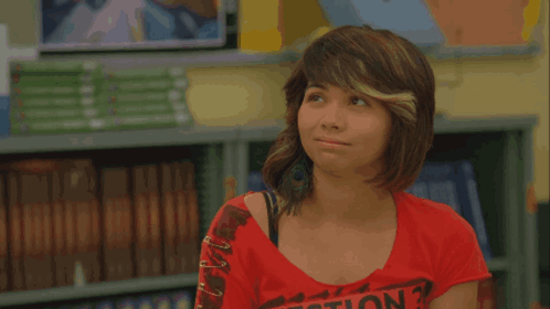 A Girl In A Red Shirt Stands In Front Of A Yellow Sign That Says Pass GIF