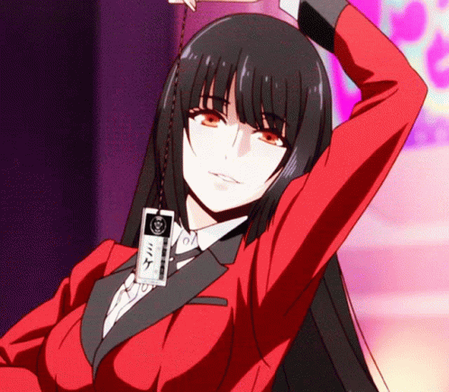 A Girl In A Red Suit Has A Card Around Her Neck That Says ' Mike ' On It GIF