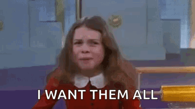 A Girl In A Red Sweater Is Saying `` I Want Them All '' With Her Arms In The Air . GIF