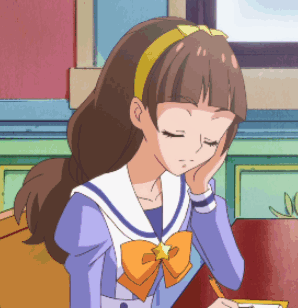 A Girl In A Sailor Suit With A Star On Her Head Is Sitting At A Table With Her Eyes Closed GIF