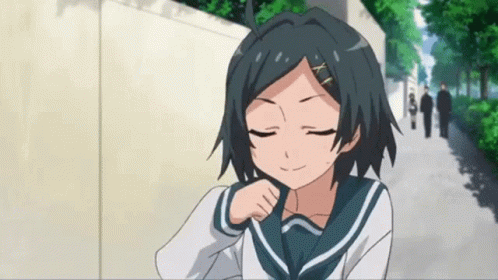 A Girl In A School Uniform Has Her Eyes Closed And Is Smiling GIF