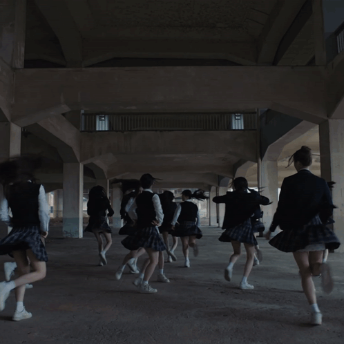 A Girl In A School Uniform Is Dancing With Her Hands In The Air GIF