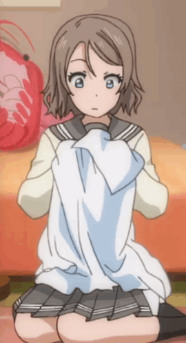 A Girl In A School Uniform Is Kneeling On The Floor GIF
