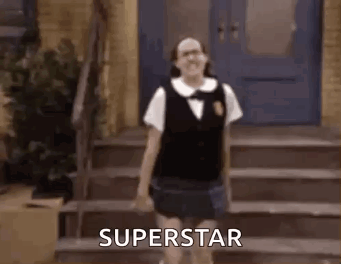 A Girl In A School Uniform Is Standing On A Set Of Stairs And Says Superstar . GIF