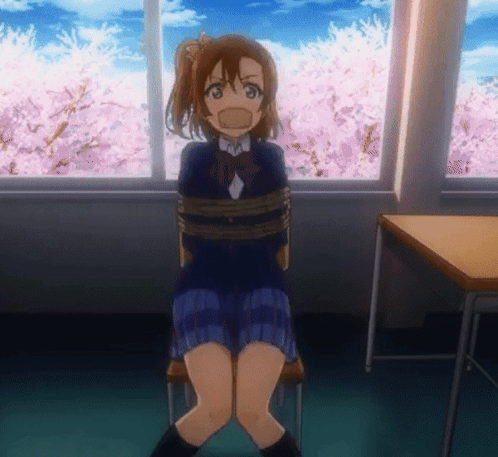 A Girl In A School Uniform Is Tied Up In A Room With Cherry Blossoms In The Background GIF