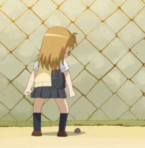 A Girl In A School Uniform Kicking A Ball GIF