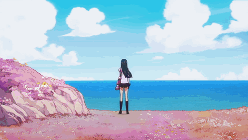 A Girl In A School Uniform Stands On A Hill Overlooking The Ocean GIF