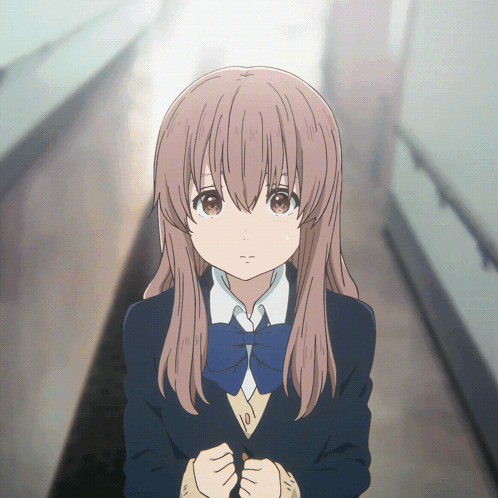 a girl in a school uniform with a blue bow tie is standing in a hallway