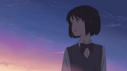 A Girl In A School Uniform With A Bow Tie Looks At The Sky GIF