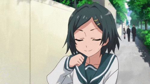 A Girl In A School Uniform With A X On Her Hair Is Smiling GIF