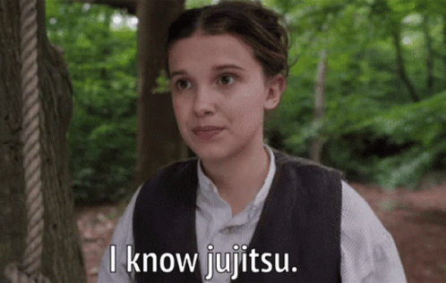 A Girl In A Vest Says I Know Jujitsu In Front Of A Tree GIF