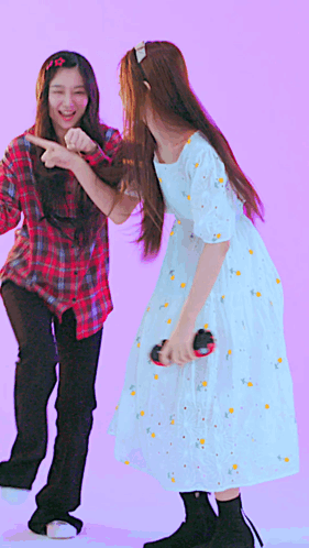 A Girl In A White Dress Is Dancing With Another Girl GIF
