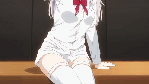 A Girl In A White Shirt And Knee High Socks Sits On A Table GIF