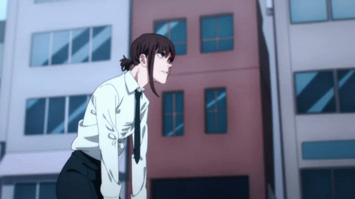 A Girl In A White Shirt And Tie Is Standing In Front Of A Building GIF
