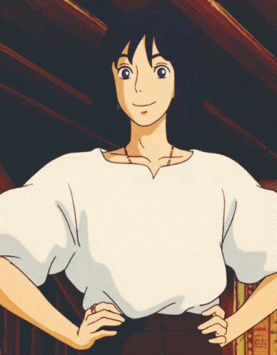 A Girl In A White Shirt With Her Hands On Her Hips Looks At The Camera GIF