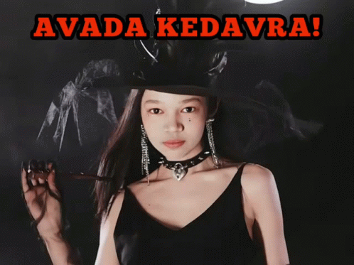 A Girl In A Witch Costume Is Holding A Glowing Object And The Caption Says Avada Kedavra GIF