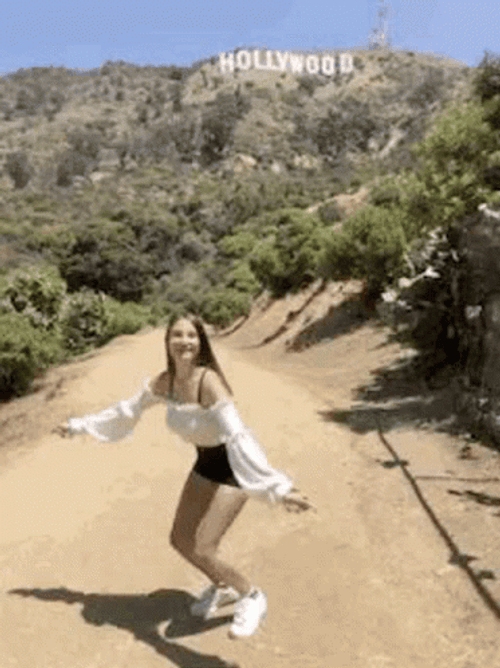 A Girl In The Mountains Jumping For Joy GIF