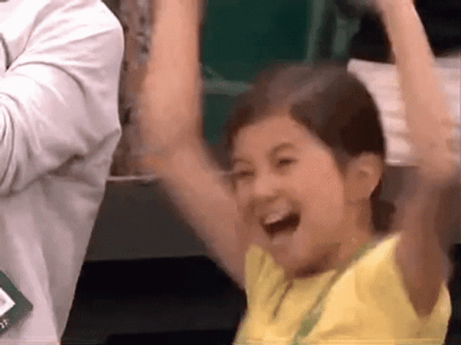 A  Girl In Yellow Jumping For Joy GIF