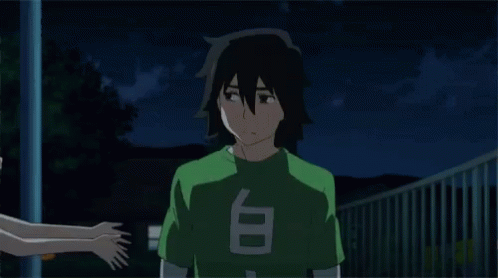 A Girl Is Hugging A Boy With A Green Shirt That Says T On It GIF