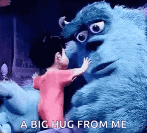 A Girl Is Hugging A Stuffed Animal From Monsters Inc . GIF