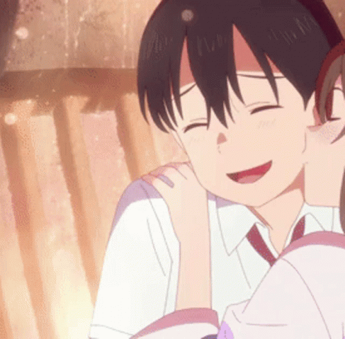 A Girl Is Kissing A Boy On The Cheek And They Are Smiling . GIF