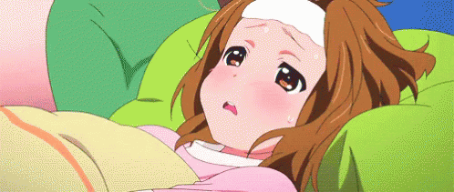 A Girl Is Laying In Bed With A Thermometer On Her Head GIF