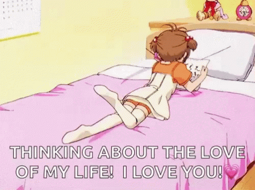 A Girl Is Laying On A Bed With Her Legs Crossed And Reading A Book . GIF