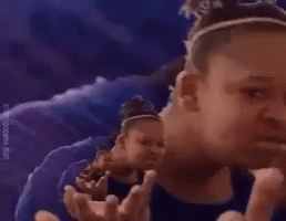 A Girl Is Making A Funny Face While Standing In Front Of A Purple Background . GIF