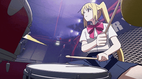 A Girl Is Playing Drums In Front Of A Sign That Says R GIF