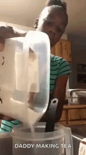 A Girl Is Pouring Milk Into A Container . GIF
