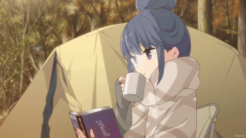 A Girl Is Reading A Book And Drinking From A Mug In Front Of A Tent GIF