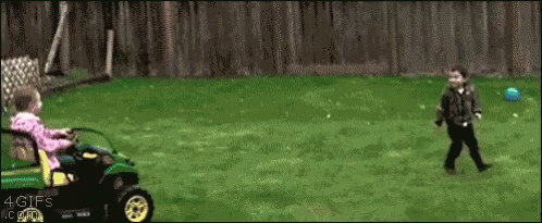 A Girl Is Riding A Lawn Mower Next To A Boy Playing With A Blue Ball GIF
