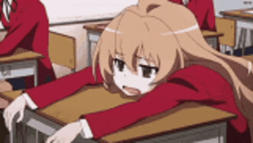 Girl Sitting At Desk With Head Down In Classroom GIF