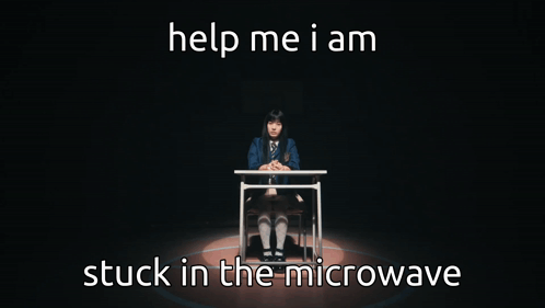 A Girl Is Sitting At A Desk With The Words Help Me I Am Stuck In The Microwave Below Her GIF