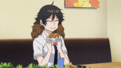 A Girl Is Sitting At A Table Eating A Sandwich And Drinking A Soda GIF