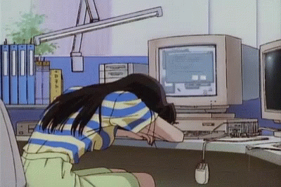 A Girl Is Sitting In Front Of A Computer With Her Head On The Desk GIF
