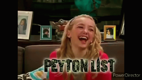 A Girl Is Sitting On A Couch Laughing And The Words Peyton List Are On The Screen Behind Her . GIF