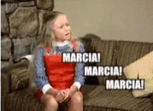 A Girl Is Sitting On A Couch With The Words Marcia GIF