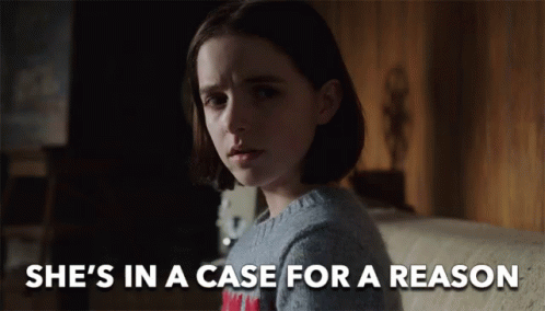 A Girl Is Sitting On A Couch With The Words She 'S In A Case For A Reason Above Her GIF