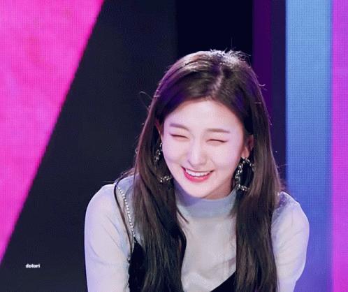 A Girl Is Smiling In Front Of A Pink And Purple Background And The Word Dotori Is On The Bottom Right GIF