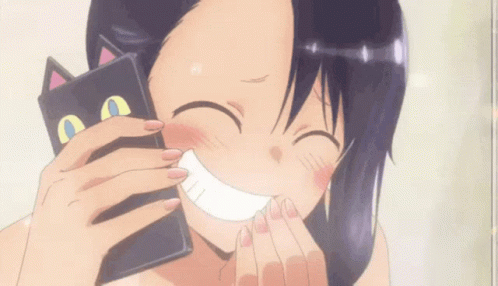A Girl Is Smiling While Holding A Black Cat Shaped Wallet GIF