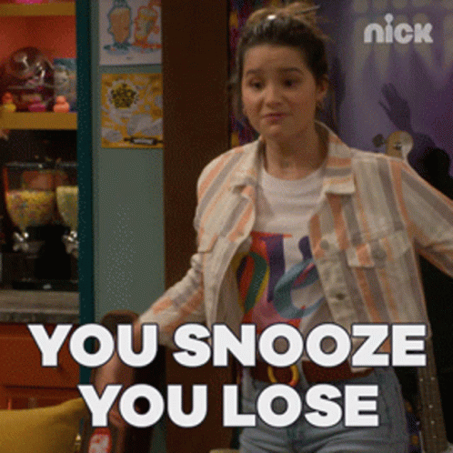 A Girl Is Standing In Front Of A Sign That Says Nick GIF