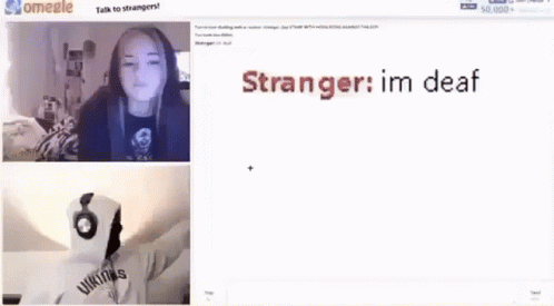 A Girl Is Standing In Front Of A Television In A Dark Room . GIF